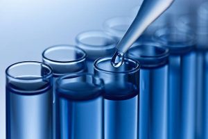 water being put into test tubes with a dropper in a water test situation