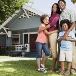 family in front of a house