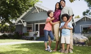 family in front of a house