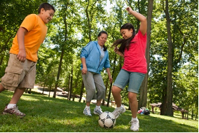family playing soccer