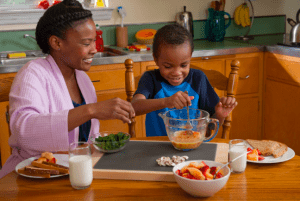 mom and boy at a table with food