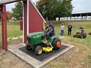 Diego gives a thumbs up after checking his second tractor into the 4-H garden tractor pull