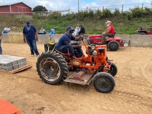Diego Marks on his tractor with it hooked to the sled ready to pull the weights