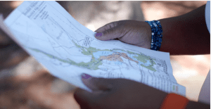 hands holding a trail map