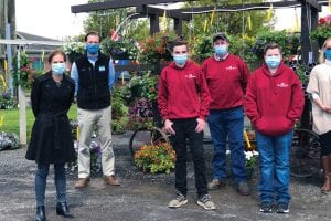 group of people in masks at a farm