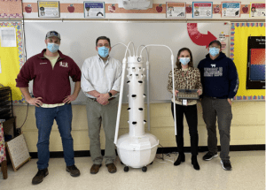 people standing in a classroom with tower garden