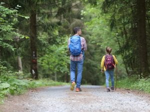 man and girl on a trail