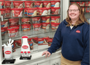 Meg Uricchio stands in front of a case of Hood ice cream