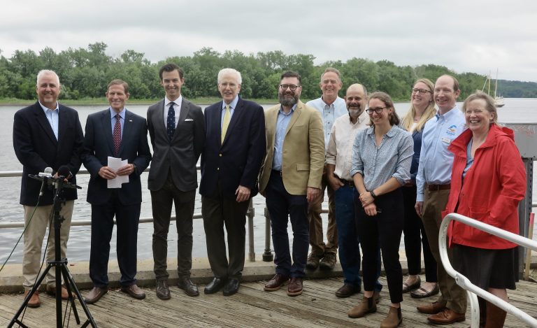 group of people standing infront of CT river