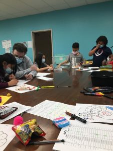 4-H youth with a mentor working on coding