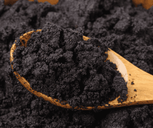 wooden spoon with coffee grounds on it