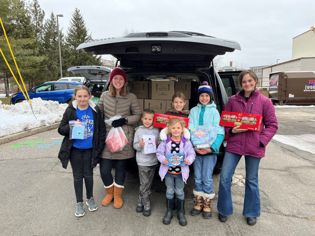 Litchfield County 4-H members holding hot chocolate and candy canes