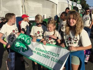 a group of young children holding a banner