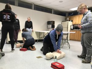 people practicing CPR on mannequins