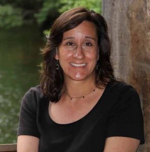 Diana Payne, white woman with medium length brown hair and black t-shirt