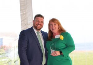 man and woman with an award