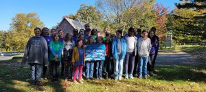 group of youth holding a sign that says thank you in many languages