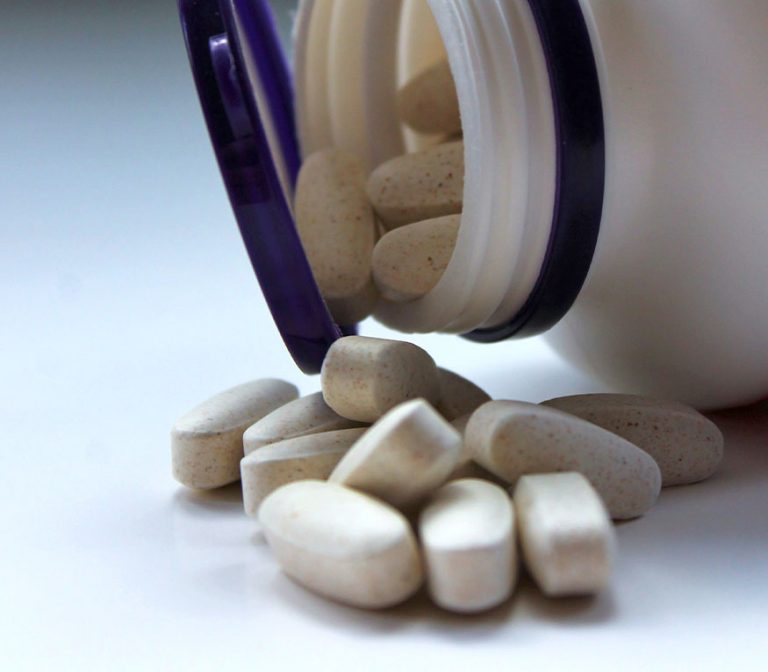 a bottle tipped over of multi vitamins