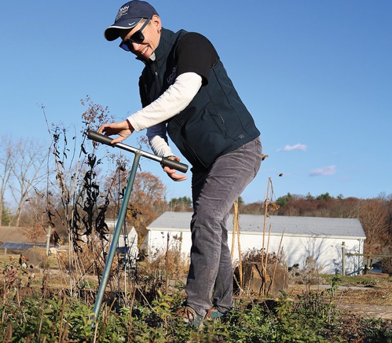 Amelia Magistrali ouside taking soil sample