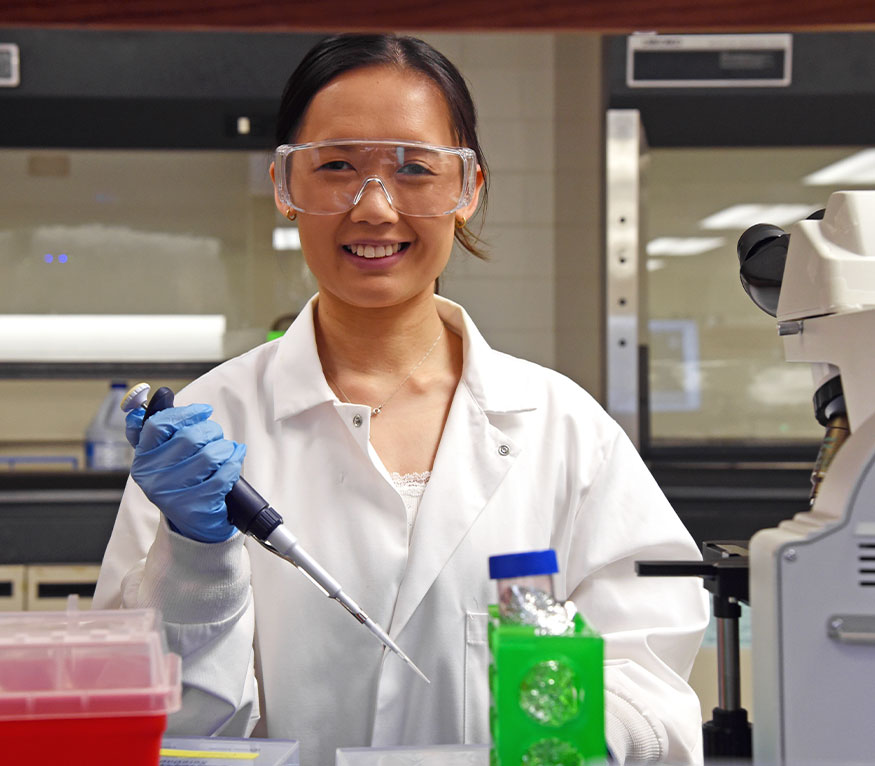 lab technician holding a tool