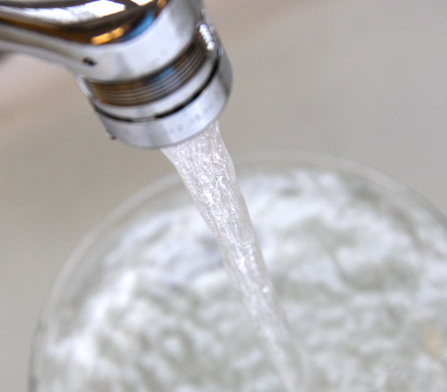 water coming out of a faucet into a glass