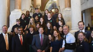 adults and youth standing on stairs in CT state capitol