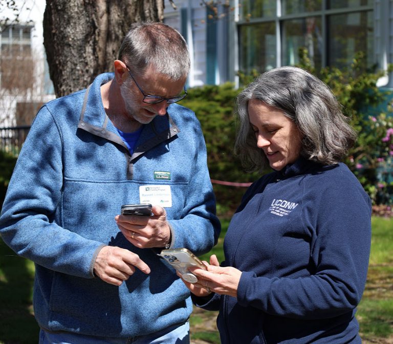 two people looking at a phone