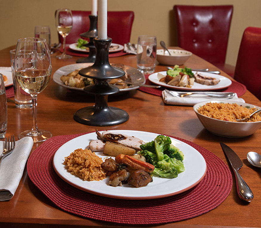 dinner table set for a holiday meal with candles in the middle