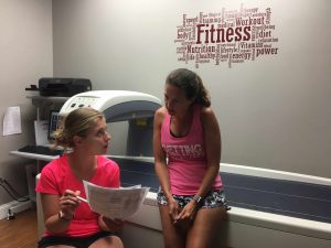 Two women reviwing papers in a medical office.