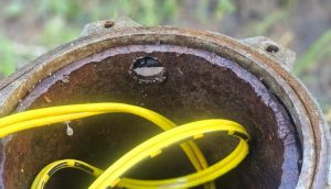 A close up photo of a metal pipe with a hle