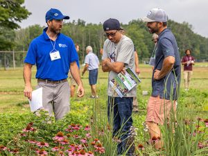 Extension educator in a pollinator garden with two program participants
