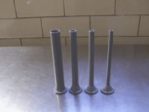 Four sausage studding horns of varying diameter on a metal table.