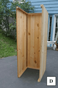 A view of a partially constructed walls of a smokehouse.