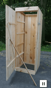 A view of the smokehouse box with the door proped open.