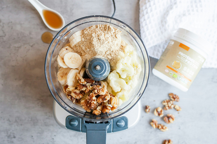 Blender full of healthy food and protein powder.